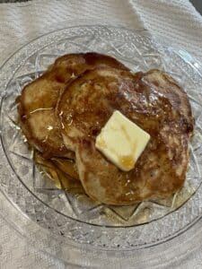 Pancakes with a pat of butter and maple syrup